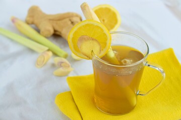 Ginger lemongrass tea hot drink with lemon on white background