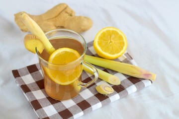 Ginger lemongrass tea hot drink with lemon on white background