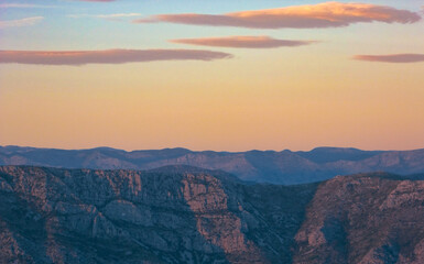 Pink sunset over blue mountains