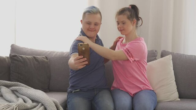 Young couple with Down Syndrome taking a selfie