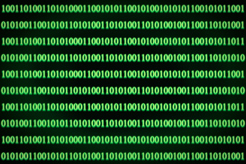 Encrypted binary ASCII computer code on black background. Green binary code computer.