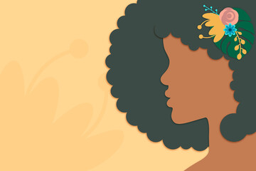 Side view of beautiful black girl with flowers in curly hair