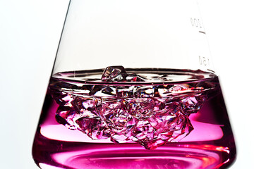 Glass flask. Liquid and crystals. Colored liquid.
