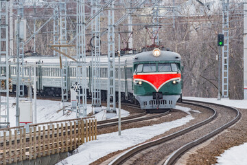 Retro passenger train approaches to the station.