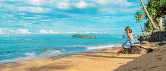 Child girl on the beach in Sri Lanka. Selective focus.