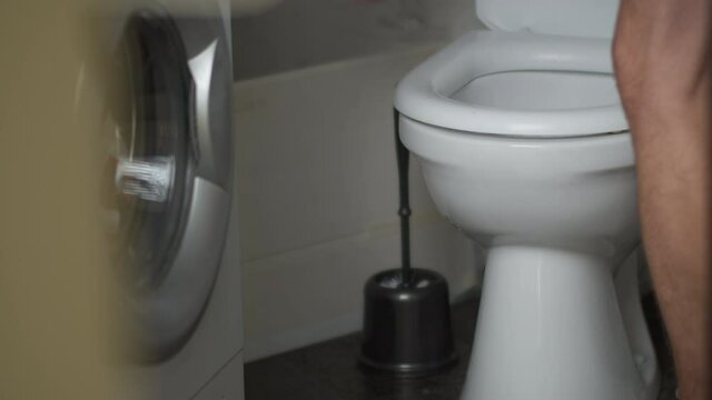 man flushes after himself in the toilet and leaves