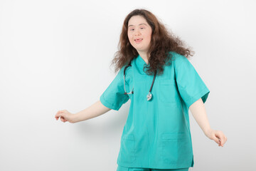 Picture of a young girl in green uniform with stethoscope standing and posing