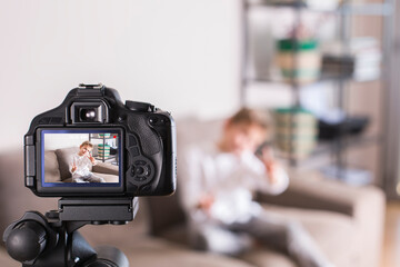 Vlogger recording social media video while sitting on the couch