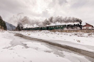 Old train with big smoke during winter time in Moldovita, Bucovina. Romaniia.