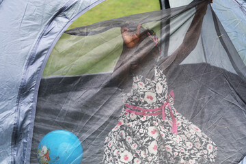 Happiness africa child in tent for relaxation and fun in the summer.