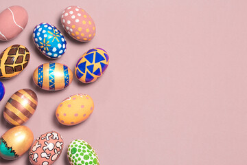 A gentle festive banner colored Easter eggs on a light pink background with room for text to copy the space. Options for coloring eggs for Easter