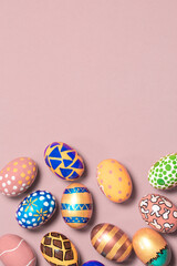 Fototapeta na wymiar A gentle festive vertical banner colored Easter eggs on a light pink background with room for text to copy the space. Options for coloring eggs for Easter