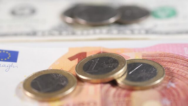 US dollars and Euros. Close slider shot of paper money and coins.