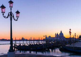 View on Venice and gondolas with purple sunset