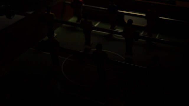 football on the table at night the light blinks team sport table, ball toy player grass color, recreation dummy. Black taca figurine table soccer miniature