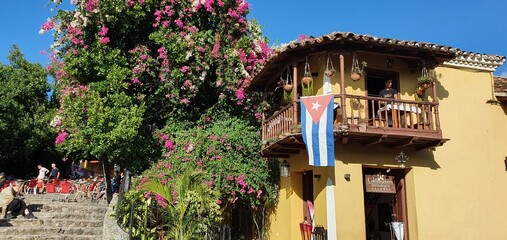 beautiful house with flowers and the cuban flag in trinidad in cuba