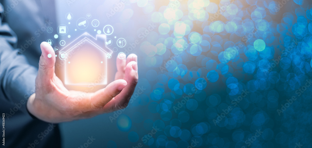 Poster man holding glowing house of smart home automation system. futuristic house system technology concep