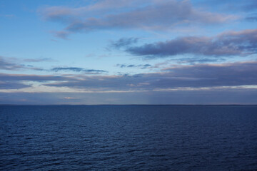 The endless sea with evening clouds on the horizon