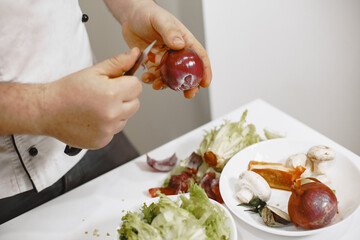 Taking care of his health. Handsome guy standing in the kitchen at home.