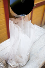 boiled water is added to a bag full of straw pellets and gypsum