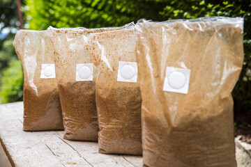 group of bags with straw substrat in it, prepared for mushroom cultivating