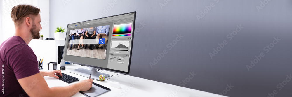Poster Designer Editing Photo On Computer