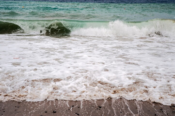 Turquoise water with the continuous flowing back and forth of the tide on the foreshore