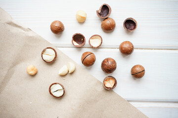 macadamia nuts on a white wooden background