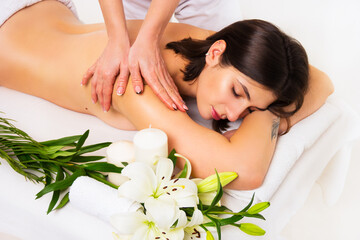 Obraz na płótnie Canvas Back and shoulder massage. Beautiful woman in the spa salon. Woman having massage