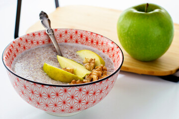 Flaxseed porridge with apples. Oatmeal porridge bowl with flax linen seeds. Healthy nutritious breakfast. Selective focus