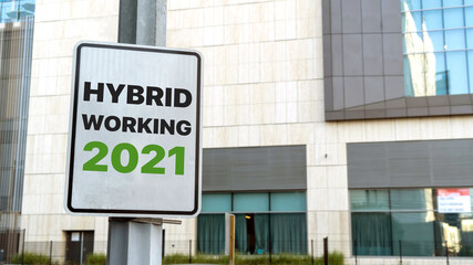 Hybrid working 2021 sign in a downtown city setting