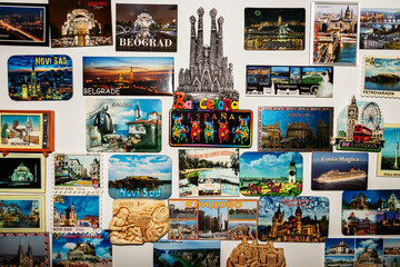 A magnetic board used as a decorative painting, on which there are different magnets with landscapes and tourist attractions from holidays in different countries in Europe