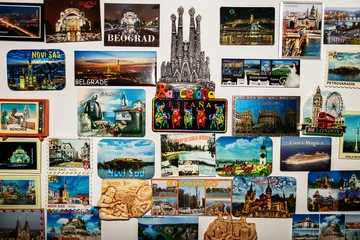 Deurstickers A magnetic board used as a decorative painting, on which there are different magnets with landscapes and tourist attractions from holidays in different countries in Europe © sorina