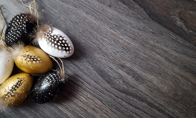 Decorative Easter eggs on a dark background with blank space for greetings. 