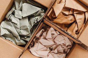 Cardboard boxes with crumpled paper inside for packaging goods from online stores, eco friendly...