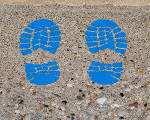 Blue shoe prints on concrete.