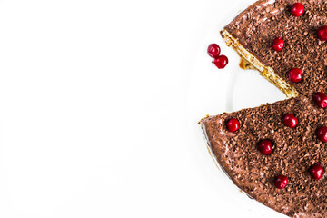 Homemade chocolate cake with cherries in a plate on a white background. Empty space for text. Flat lay top-down. Header, banner for site design. 