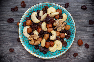 mix of various nuts and raisins on a plate top view