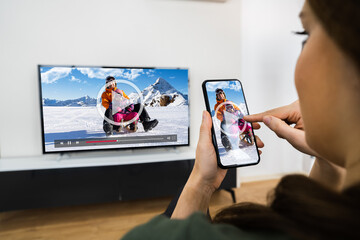 Woman Watching TV Streaming From Smartphone