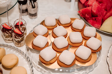 Sweet cakes at a wedding banquet. Catering, sweet festive buffet. Candy bar