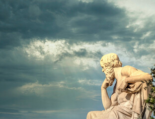 Socrates the ancient Greek philosopher in deep thoughts under impressive sky, Athens Greece