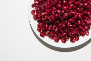 Garnet seeds in white plate