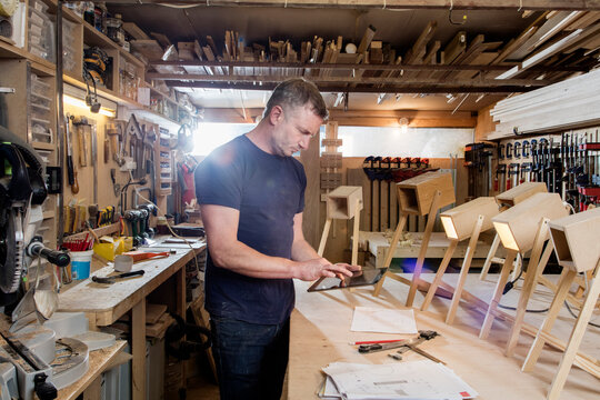 Designer using digital tablet by prototypes of table lamps
