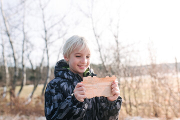 Boy reading clue note in countryside