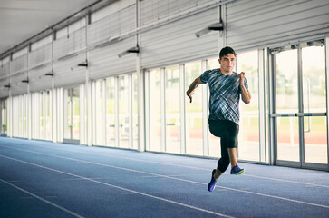 Runner training on indoor running track