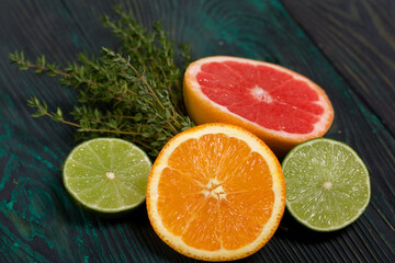 Halves of lime, orange, grapefruit and thyme.