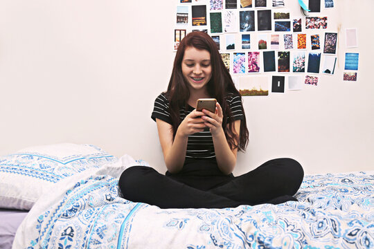 Teenager social networking on bed