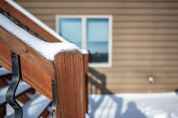 Snow covered wooden steps on a residential house