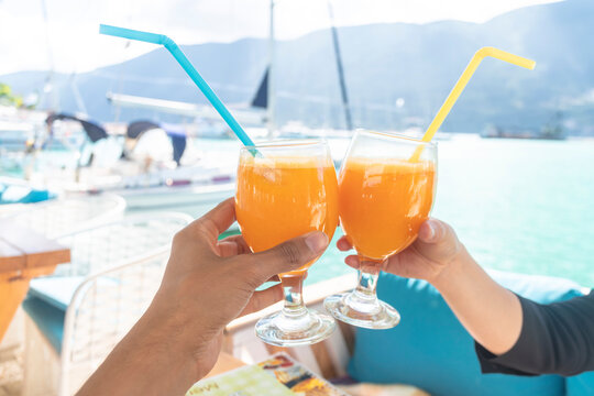 Couple toasting with cocktail on boat, Lefkada Island, Levkas, Greece