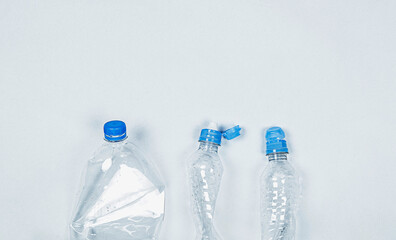 plastic bottles on gray background, ecology problems